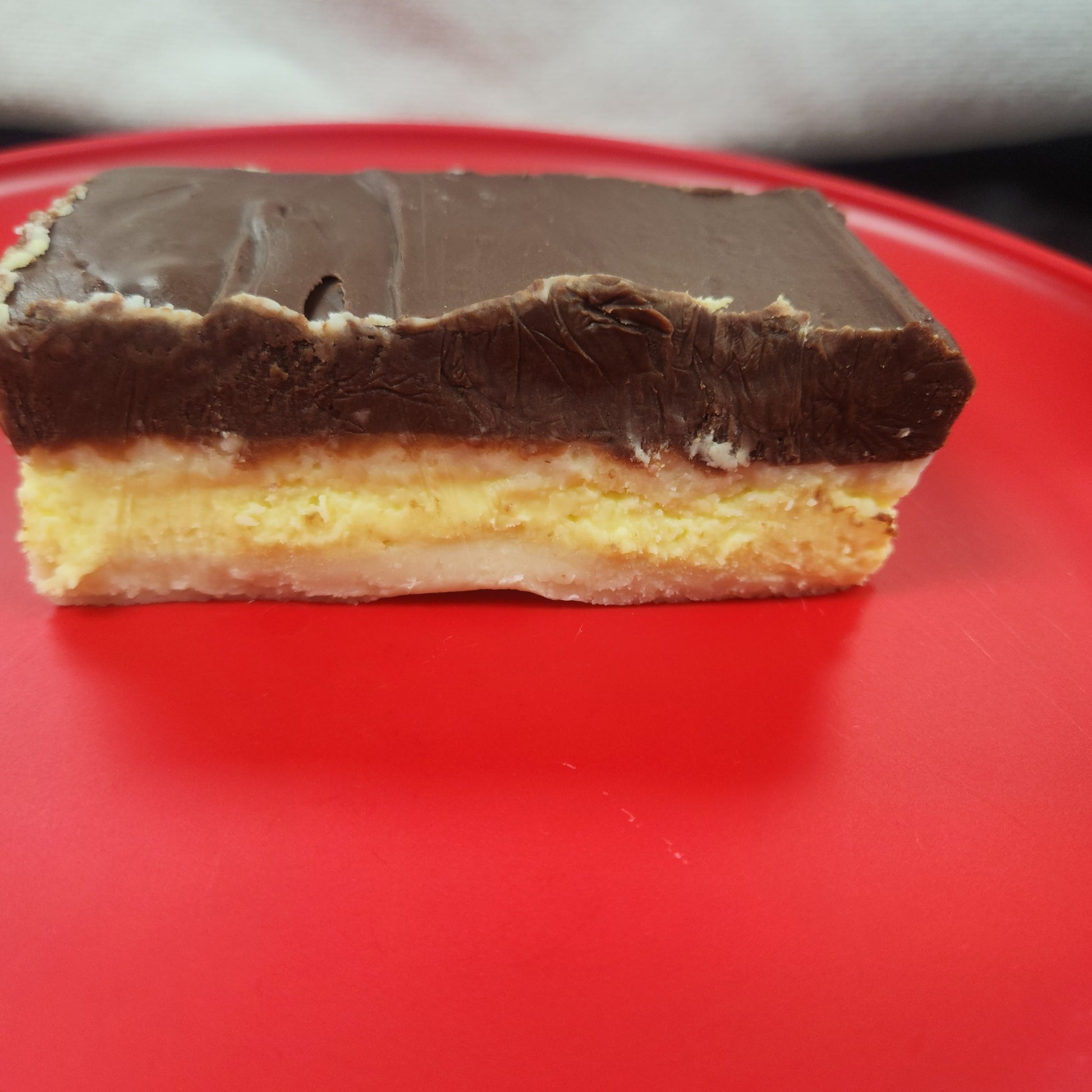 Boston cream fudge on a red plate. 