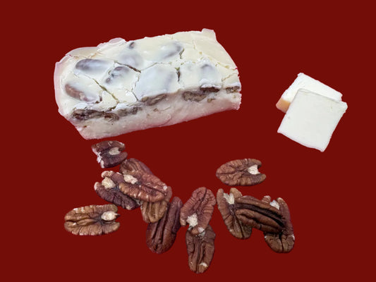 8 ounce piece of Butter Pecan Fudge surrounded by pecans and slices of butter.